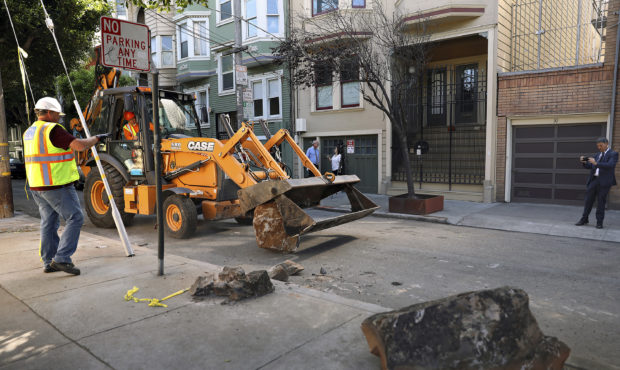 In this Monday, Sept. 30, 2019, photo, a San Francisco Public Works crew removes boulders from a si...