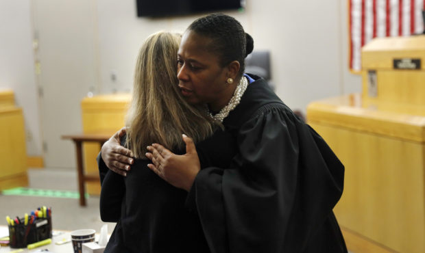State District Judge Tammy Kemp gives former Dallas Police Officer Amber Guyger a hug before Guyger...