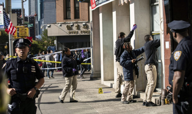 New York Police Department officers investigate the scene of an attack in Manhattan's Chinatown nei...