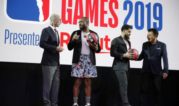 NBA Commissioner Adam Silver, left, talks to Houston Rockets' P. J. Tucker while Toronto Raptors' F...