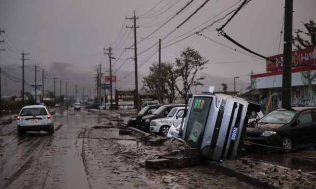 Typhoon-damaged cars sit on the street covered with mud Monday, Oct. 14, 2019, in Hoyasu, Japan. Re...