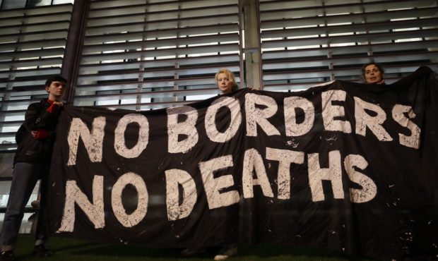 Demonstrators hold a banner during a vigil for the 39 lorry victims, outside the Home Office in Lon...