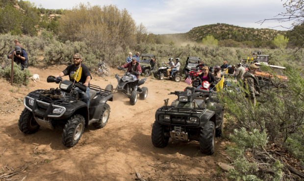 FILE - In this May 10, 2014, file photo, people ride ATV's into Recapture Canyon north of Blanding,...