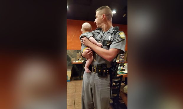 Kentucky State Trooper Aaron Hampton held a fussing baby so his mother could finish her meal....