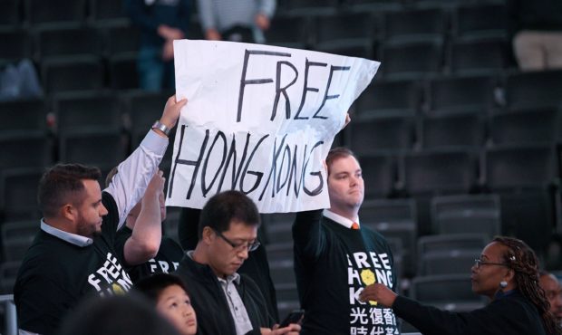 Activists hold up a sign before an NBA exhibition basketball game between the Washington Wizards an...