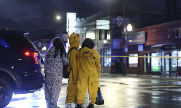 A group of children view a crime scene, where a seven-year-old girl was shot while trick-or-treatin...