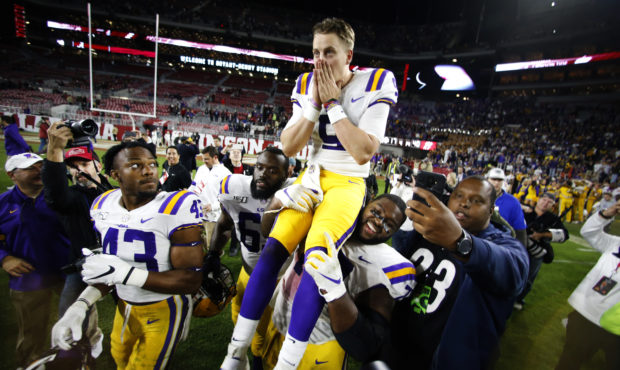 LSU quarterback Joe Burrow (9) is carried off the field by his teammates after defeating Alabama 46...