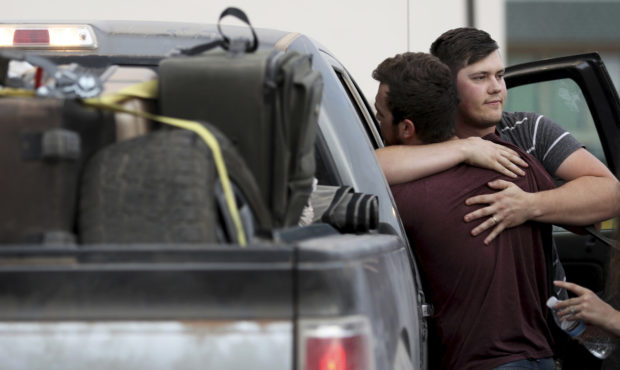 Cole Langford, left, and Hayden Spenct, of the Mormon colony in La Mora, Mexico, hug during a rende...