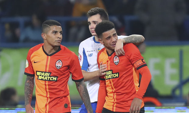 Shakhtar's Brazilian player Taison, right, reacts as he leaves the pitch after he was red-carded fo...