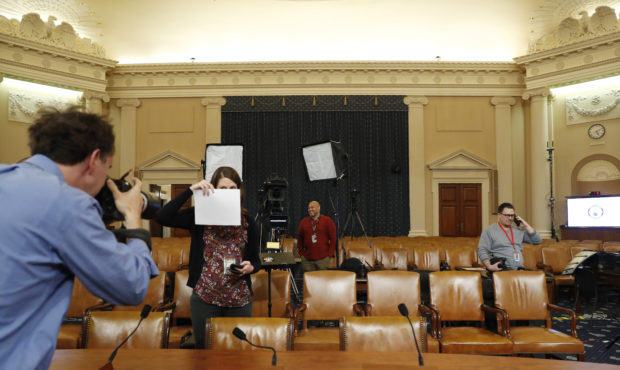 A photographer sets a white balance in the hearing room where the House will begin public impeachme...