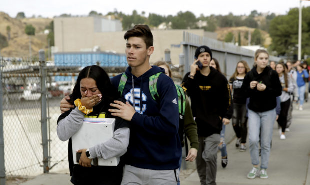 Students are escorted out of Saugus High School after reports of a shooting on Thursday, Nov. 14, 2...