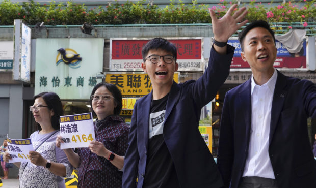 Election winner candidate Kelvin Lam, right, and pro-democracy activist Joshua Wong, second right, ...