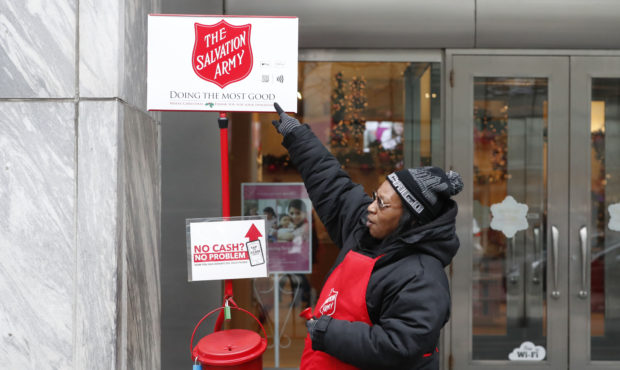 In this Friday, Nov. 15, 2019, photo, bell ringer Carolyn Harper points to two ways to donate via m...