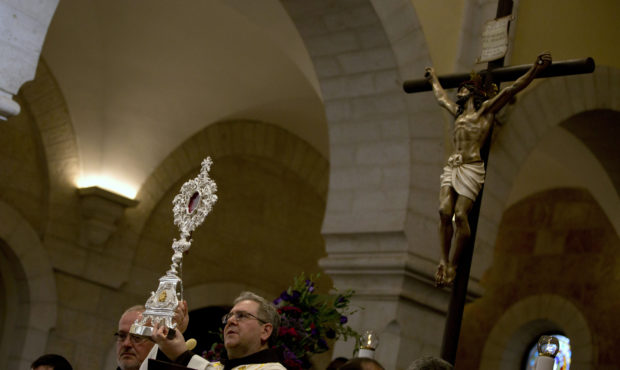 Custodian of the Catholic Church in the Holy Land, Francesco Patton holds a wooden relic believed t...