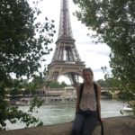 Katie in France with the Eiffel Tower behind her. 