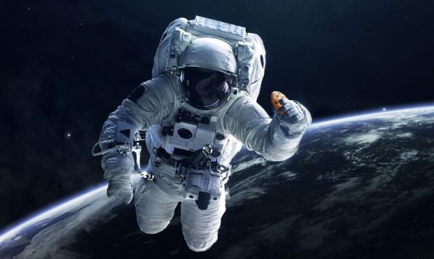 In this photo illustration provided in a press release by DoubleTree, an astronaut holds a cookie i...