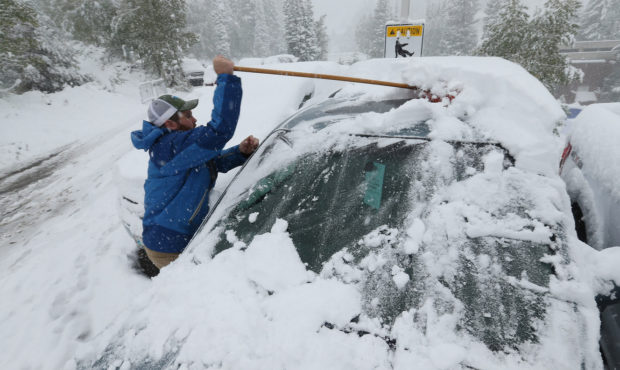 Charlie Van Dyke clears the snow off a car at Snowbird in Little Cottonwood Canyon on Sunday, Sept....