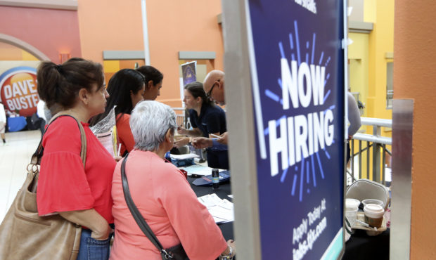 FILE - In this Oct. 1, 2019, file photo people wait in line to inquire about job openings with Mars...