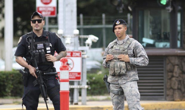 Security stands guard outside the main gate at Joint Base Pearl Harbor-Hickam, in Hawaii, Wednesday...