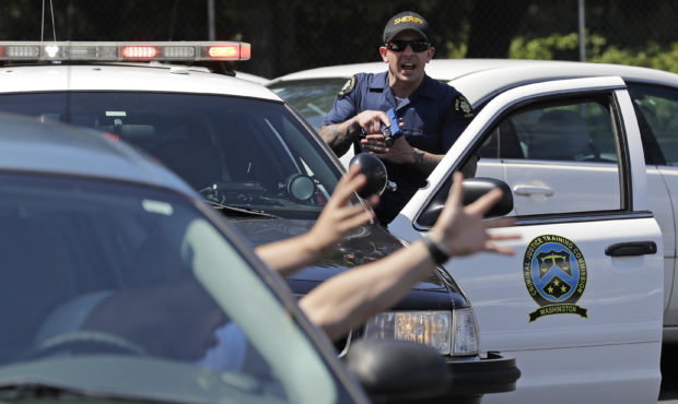 In this July 16, 2019, photo, a King County Sheriff's deputy holds a training weapon as he practice...