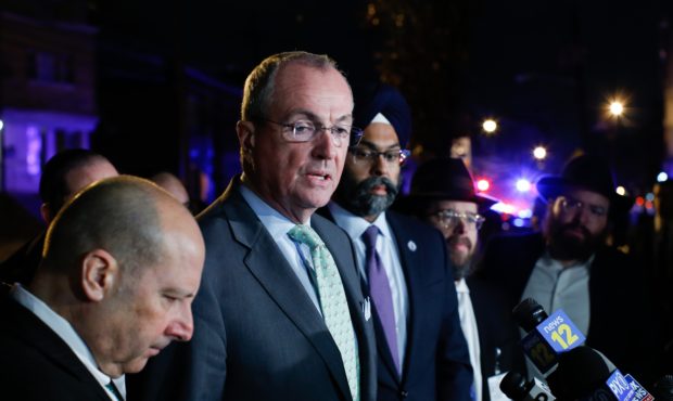 New Jersey Gov. Phil Murphy speaks with media near the scene following reports of gunfire, Tuesday,...