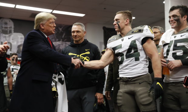 President Donald Trump shakes hands with Army player Cole Christiansen in Philadelphia, Saturday, D...