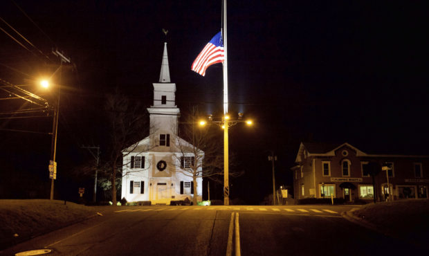 FILE - In this Dec. 15, 2012 file photo, a U.S. flag flies at half-staff on Main Street in Newtown,...