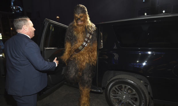 A Chewbacca character exits a car as he arrives at the world premiere of "Star Wars: The Rise of Sk...