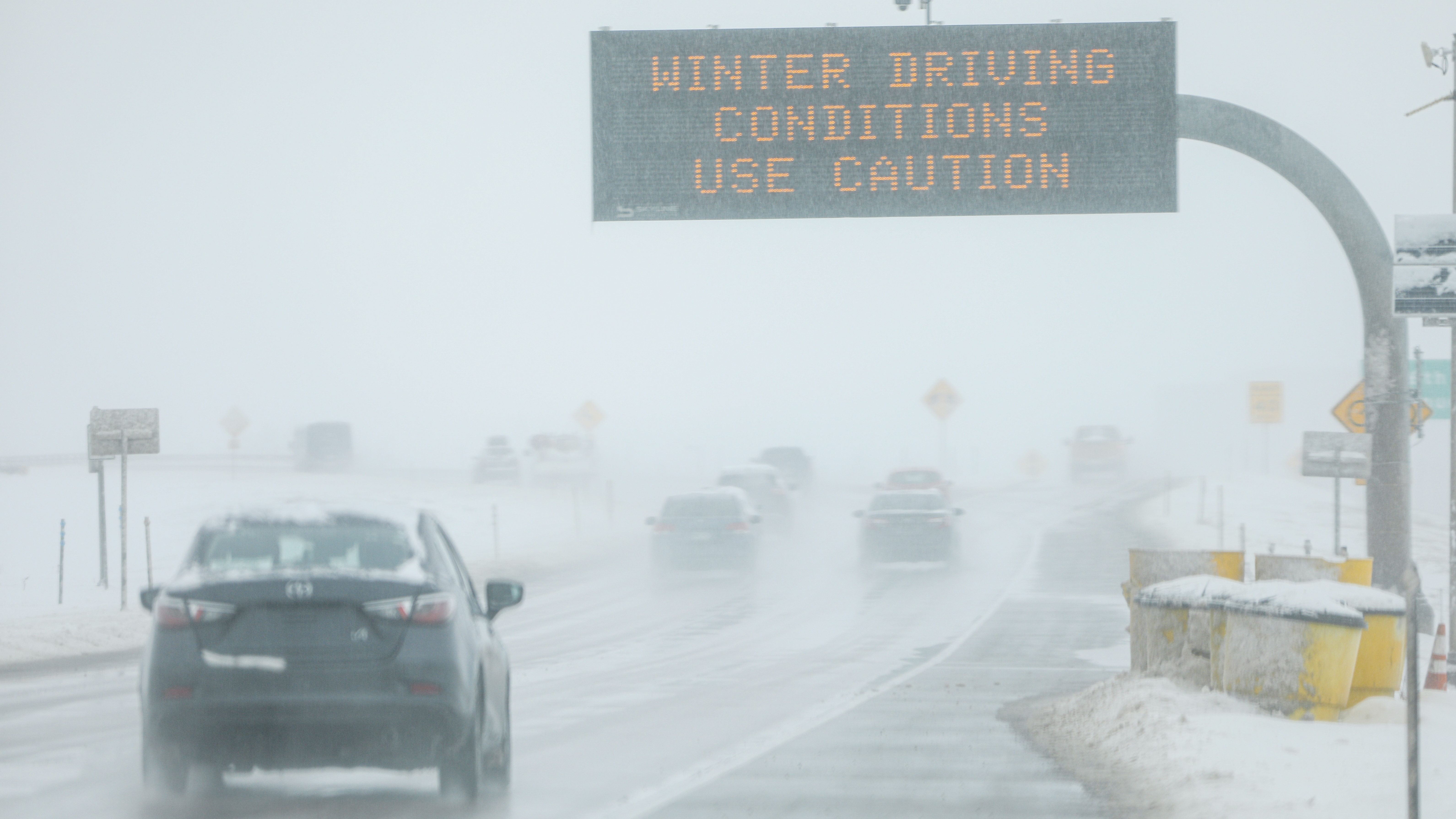 Drivers make their way along slick and snowy roads on Nov. 26, 2019 in Denver, Colorado. A strong w...
