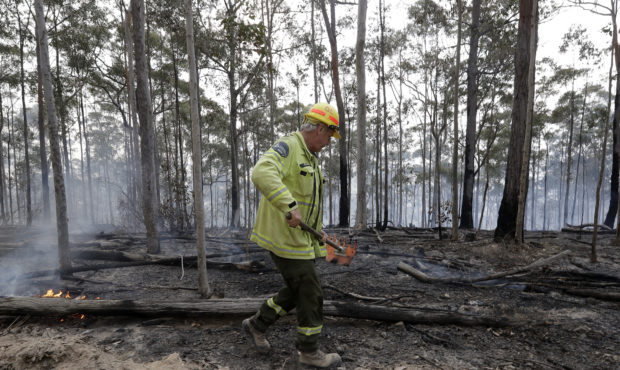 Forestry Corportaion worker Dale McLean patrols a controlled fire as they work at building a contai...