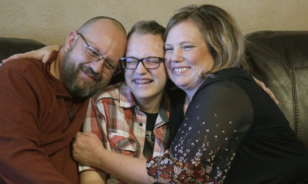 Dex Rumsey, 15, is photographed with his mother Robyn and father Clay Friday, Jan. 17, 2020, in Roy...