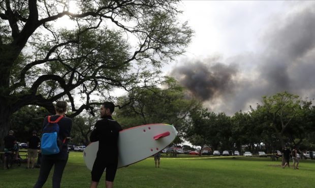 Aina Haina resident Kai Ohashi, right, and Waikiki resident Lucy Taylor observe billowing smoke fro...