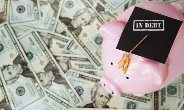 piggy bank with graduation cap next to money student loan debt...