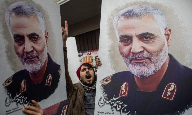 ISTANBUL, TURKEY - JANUARY 05: People hold posters showing the portrait of Iranian Revolutionary Gu...