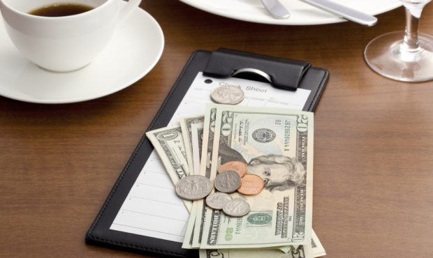 Guest check with Cash and Coin on white background. Photo: Getty Images...