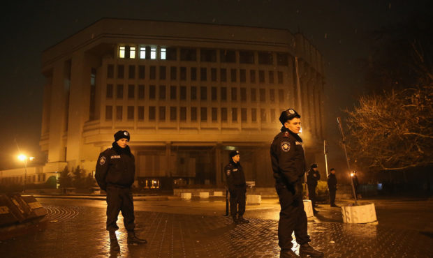 SIMFEROPOL, UKRAINE - FEBRUARY 27:  Police stand guard outside the Crimea regional parliament build...