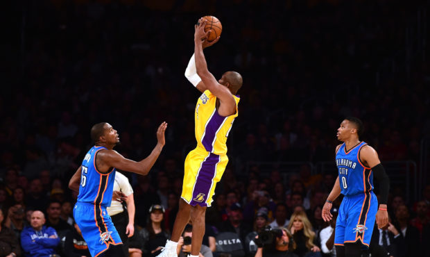 LOS ANGELES, CA - DECEMBER 23:  Kobe Bryant #24 of the Los Angeles Lakers shoots a jumper between K...