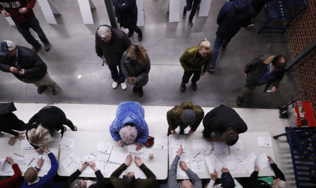 Caucus goers check in at a caucus at Roosevelt Hight School, Monday, Feb. 3, 2020, in Des Moines, I...