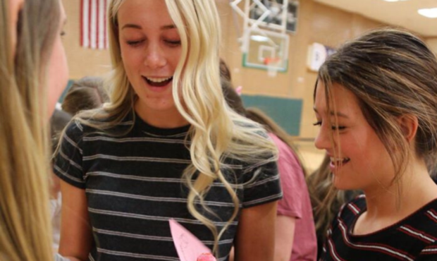 Ninth-grade girls in gym class enjoy reading their candygrams. (Photo: Davis School District)...