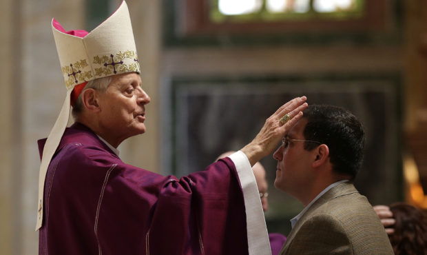 WASHINGTON, DC - FEBRUARY 18:  Cardinal Donald Wuerl places ashes on the foreheads of Catholics dur...