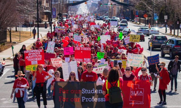 A group of teachers, parents and students march up State Street in Salt Lake City to the Utah State...