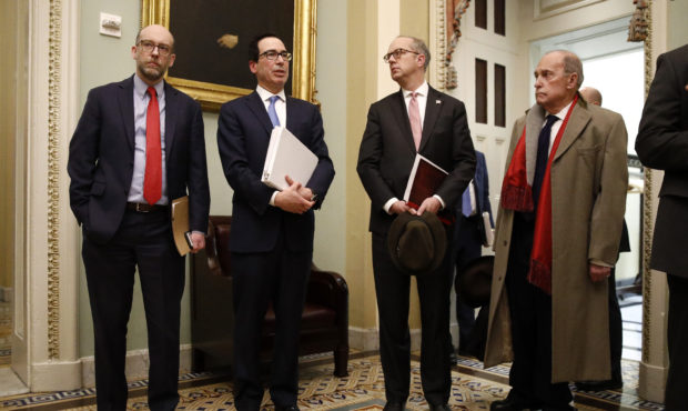 Treasury Secretary Steve Mnuchin, second from left, speaks with members of the media as he departs ...