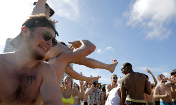 Spring break revelers party on the beach, Tuesday, March 17, 2020, in Pompano Beach, Fla. As a resp...