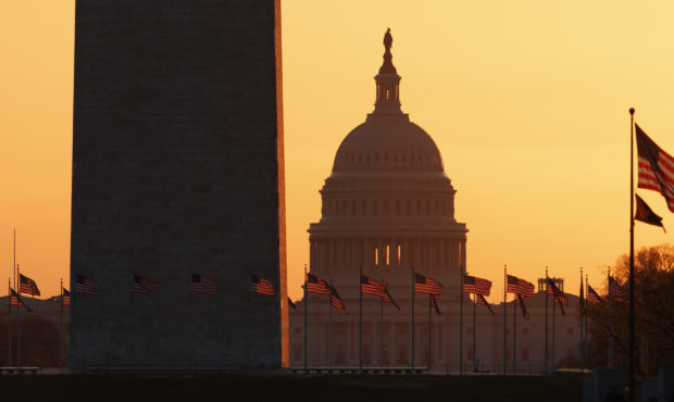 The Washington Monument and the U.S. Capitol are seen in Washington, at sunrise Wednesday, March 18...