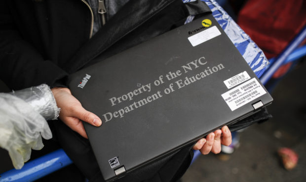 Anna Louisa, 18, receives her school laptop for home study at the Lower East Side Preparatory Schoo...