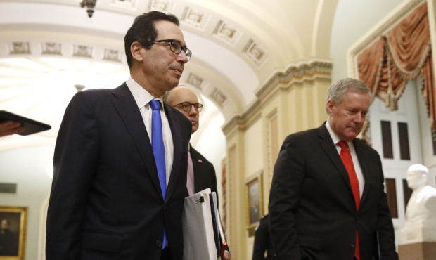 Treasury Secretary Steven Mnuchin, left, accompanied by White House Legislative Affairs Director Er...