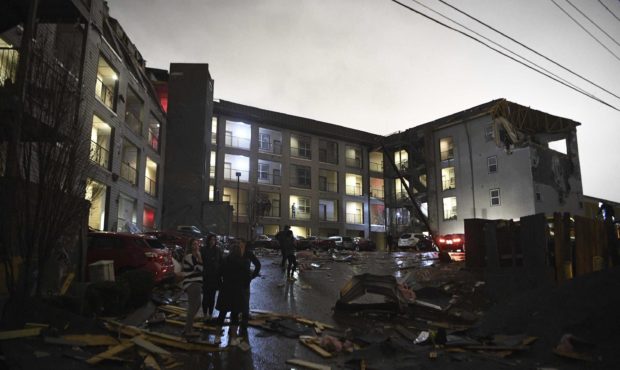 Debris is scattered across the parking lot of a damaged apartment building after a tornado hit Nash...