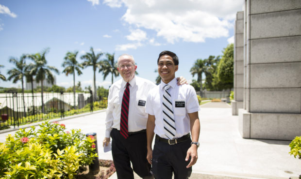 A senior elder missionary walking with a young elder missionary in the Philippines. (Courtesy of Th...
