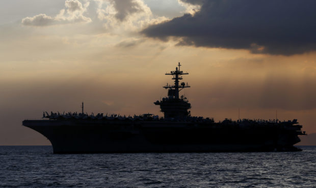 FILE - In this April 13, 2018, file photo the USS Theodore Roosevelt aircraft carrier is anchored o...