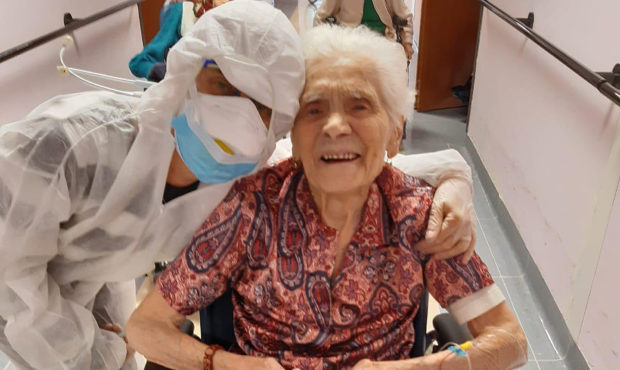 In this photo taken on April 1, 2020, 103-year-old Ada Zanusso, poses with a nurse at the old peopl...